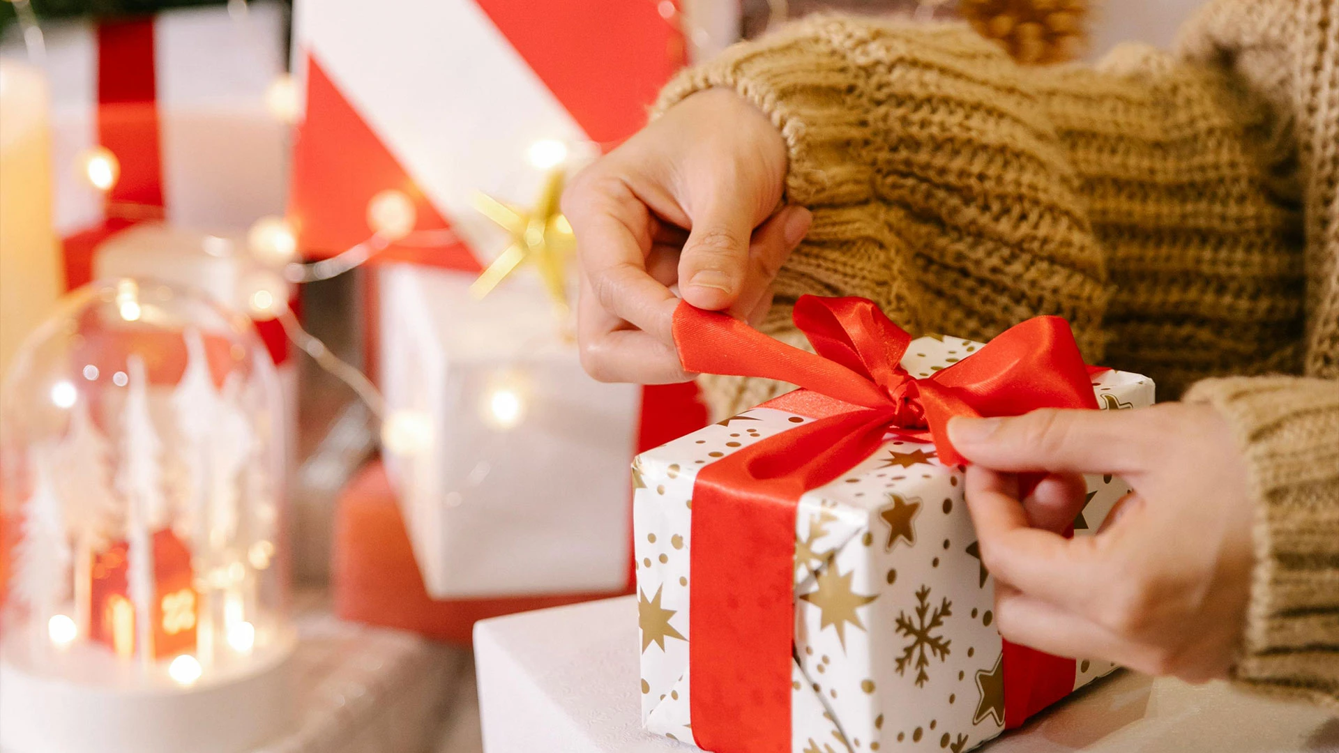A woman wrapping a present for Christmas | Holiday Wish List