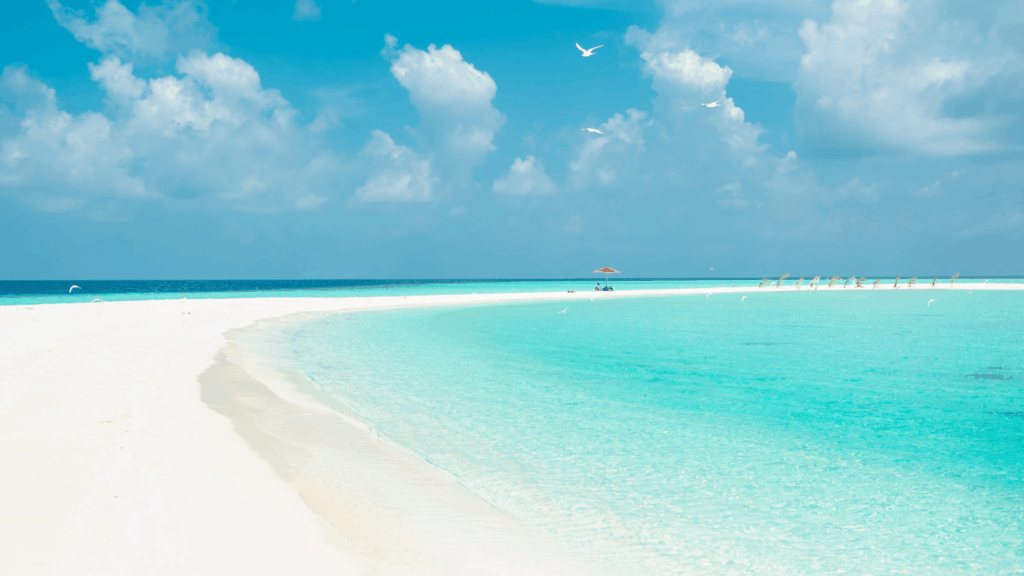 Bright blue ocean waters and a white sandy beach in Nassau, Bahamas