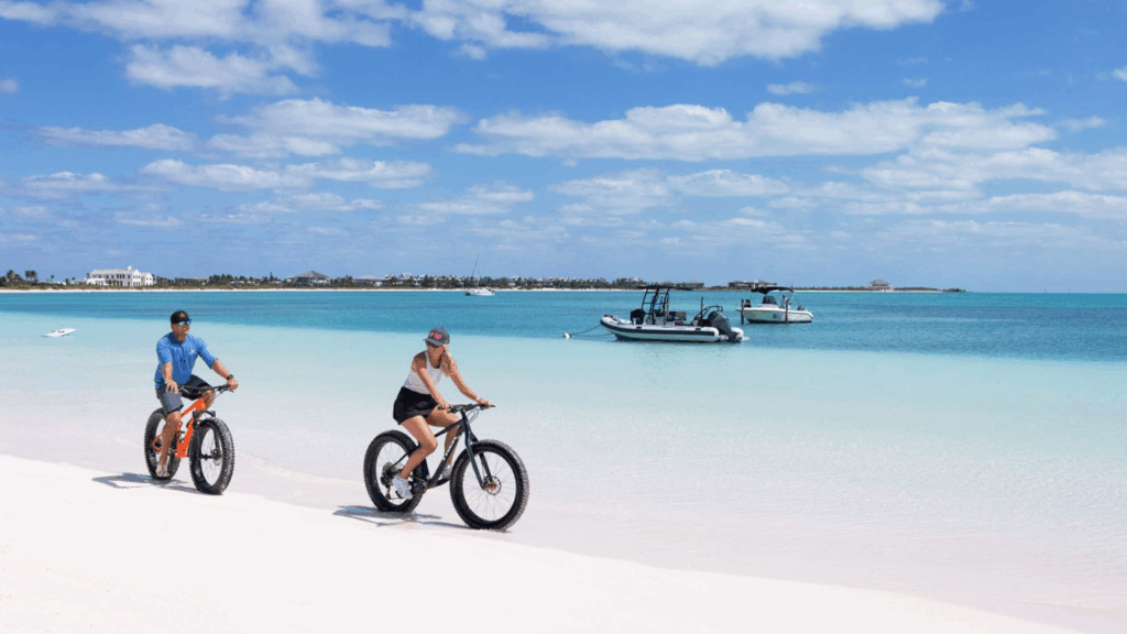 Two bikers on a beach during a Bahamas vacation.