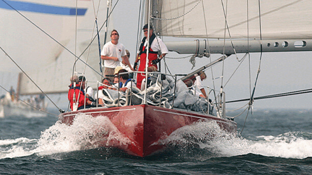 during the Martha's Vineyard regatta, a red yacht with crew sails in the ocean.