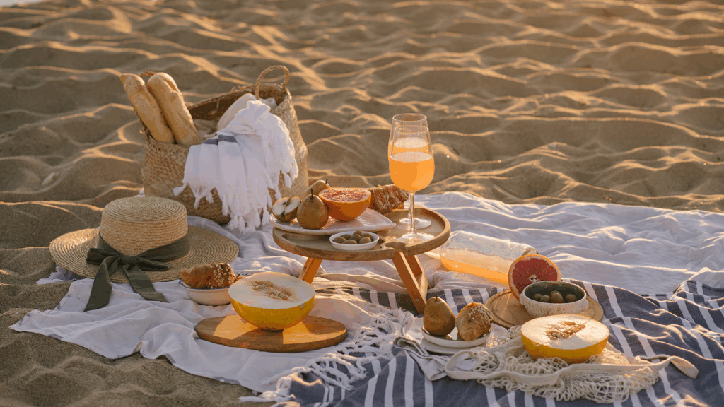 A beach picnic spread on a blanket in the sand, sometimes one of the best places to eat in Martha's Vineyard.