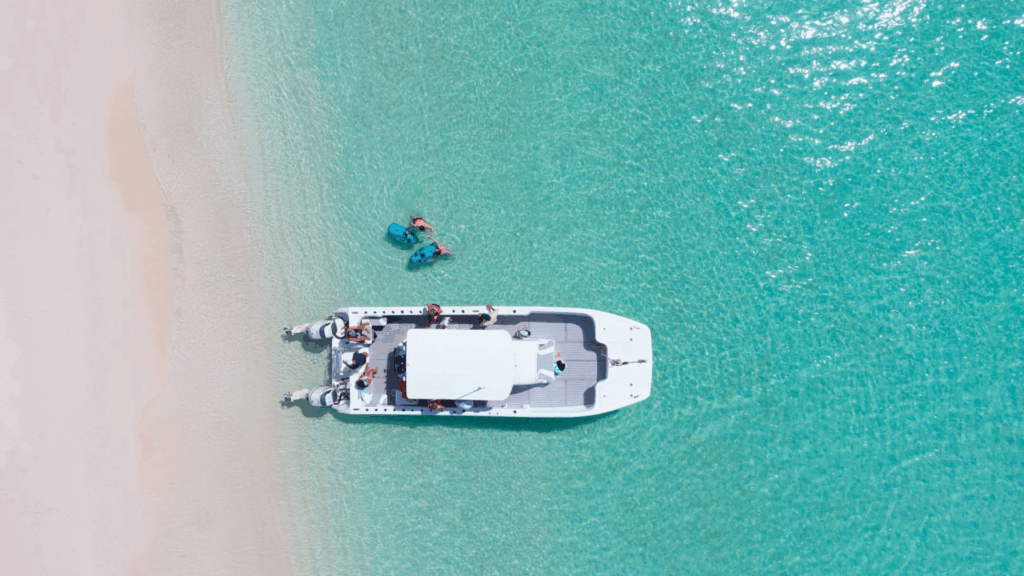 Overhead view of a white ocean yacht with turquoise waters