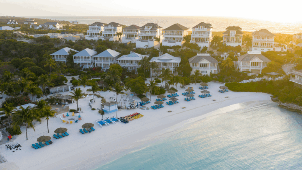 beach residences in Marsh Harbour as the sun sets on the water