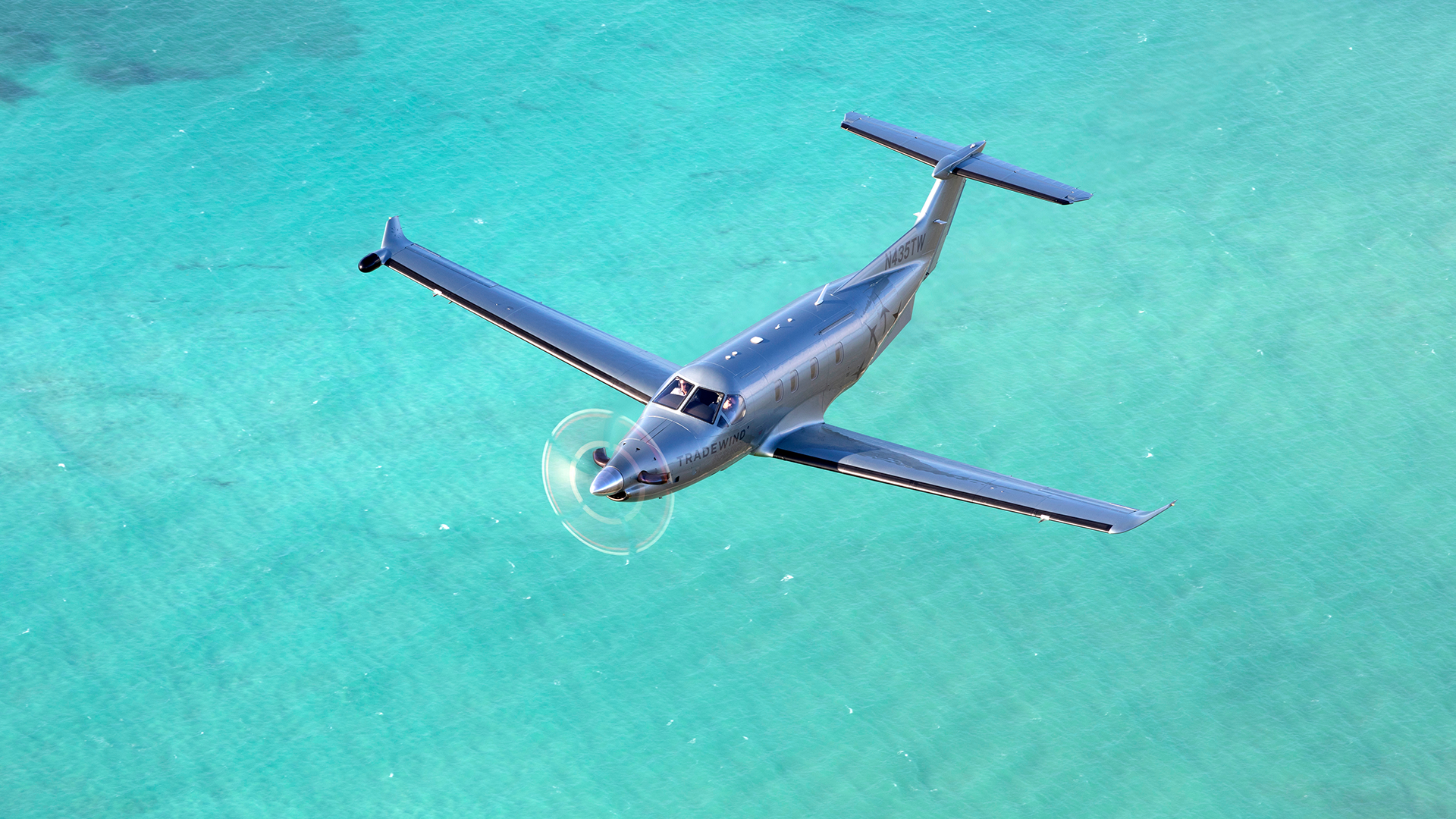flying to Nassau over turquoise waters