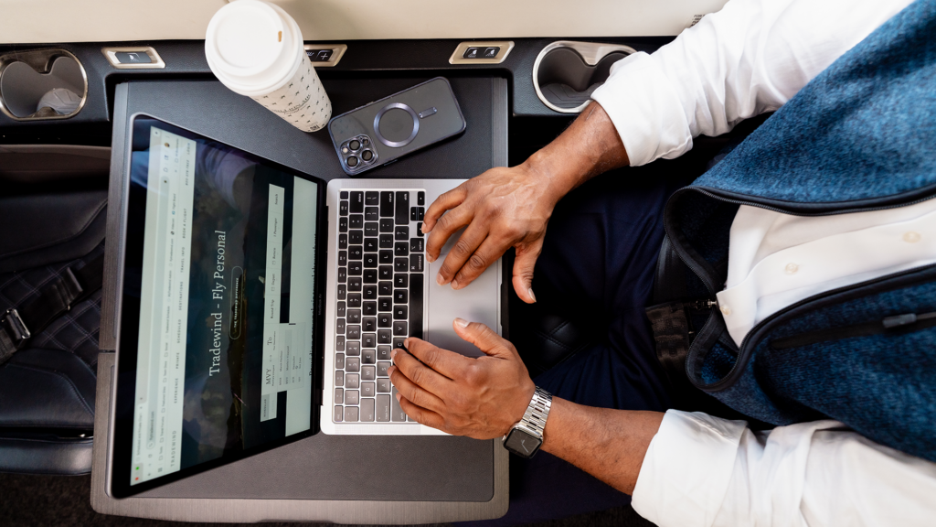 A man working on his laptop during a flight